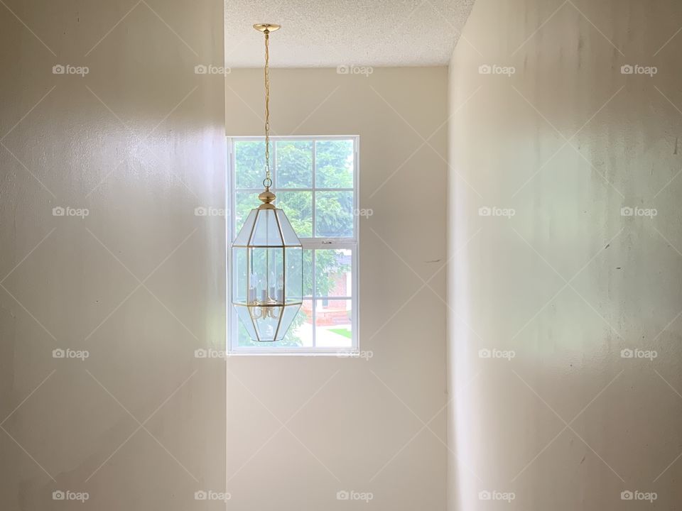 A photo of a light fixture in my house. There are three walls in this photo 2 of them on the sides. I love this photo because it looks so different when you flip it in different directions.