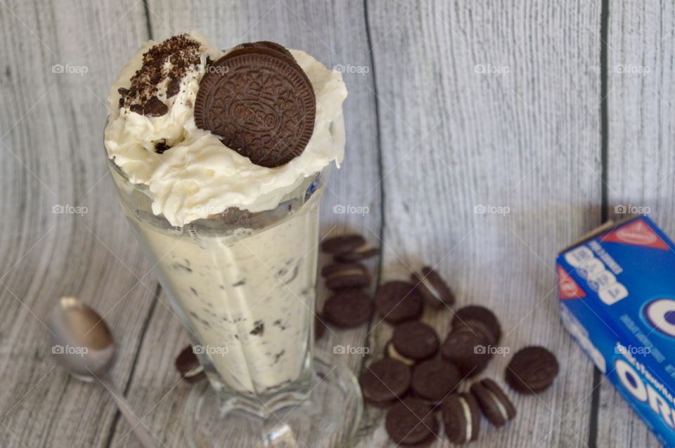 Oreo cookie milkshake with a wooden rustic white background
