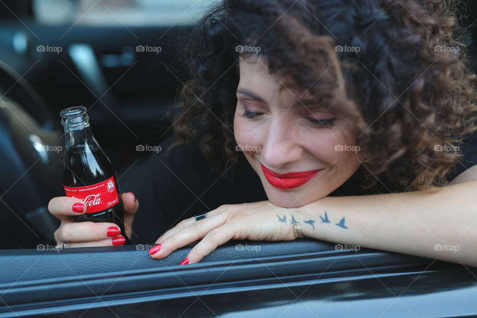 Cute girl drink Coca-Cola, happy emotional women, ref lips and beautiful smile 