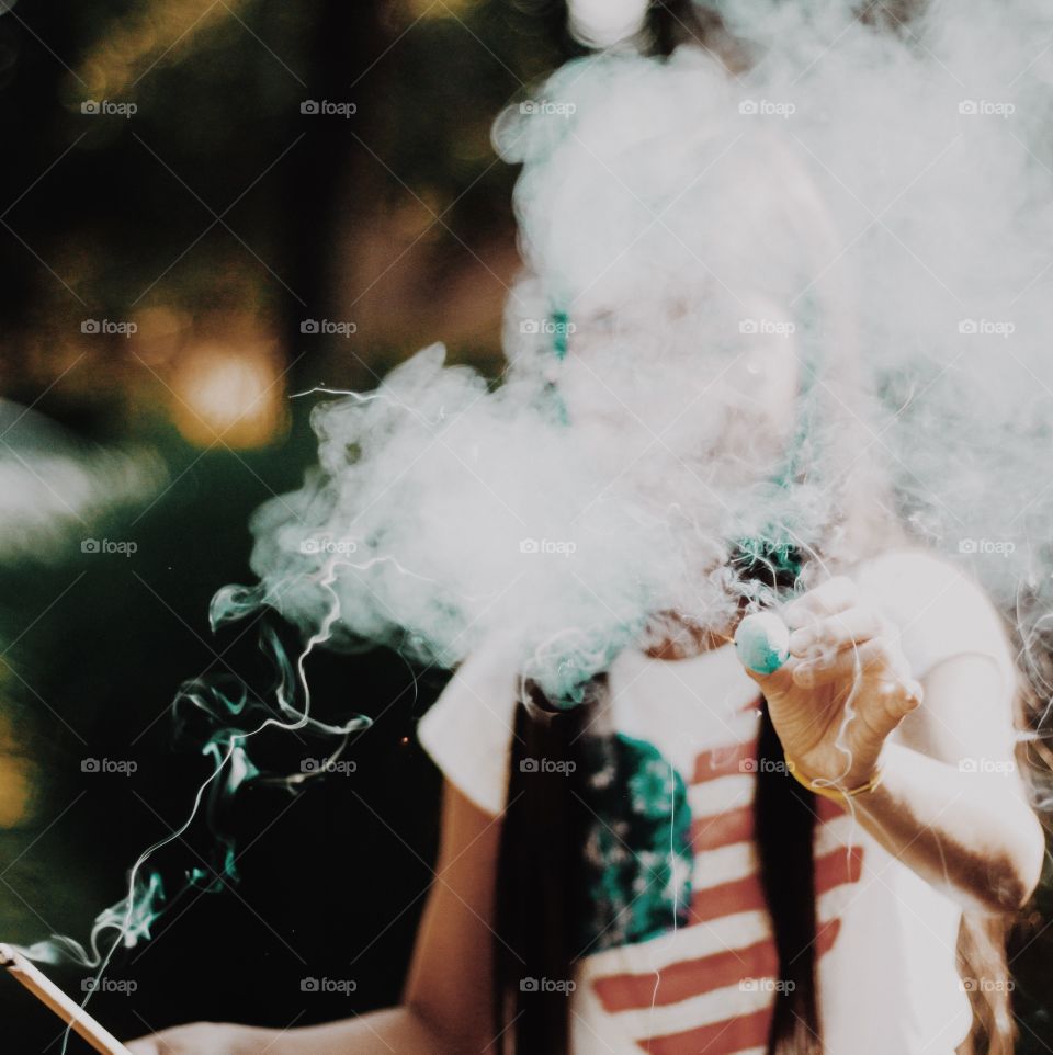 Close-up of a person holding firecracker in hand