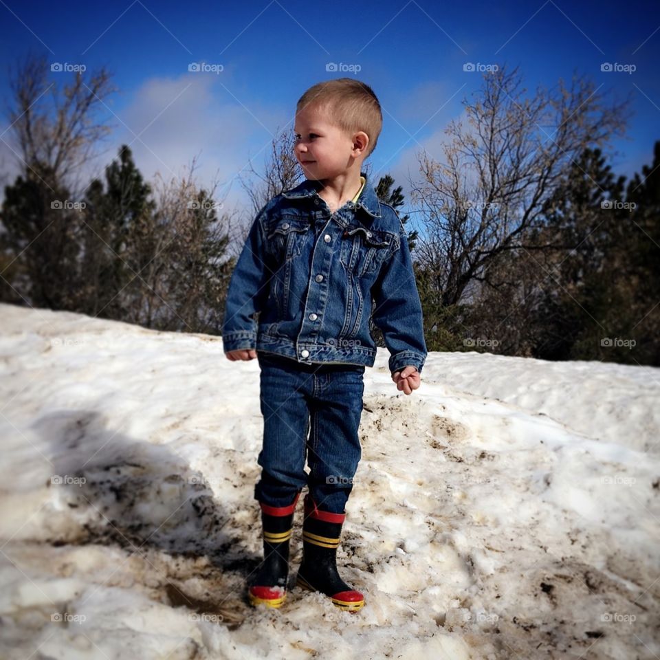 Just a boy in his fireman boots. 