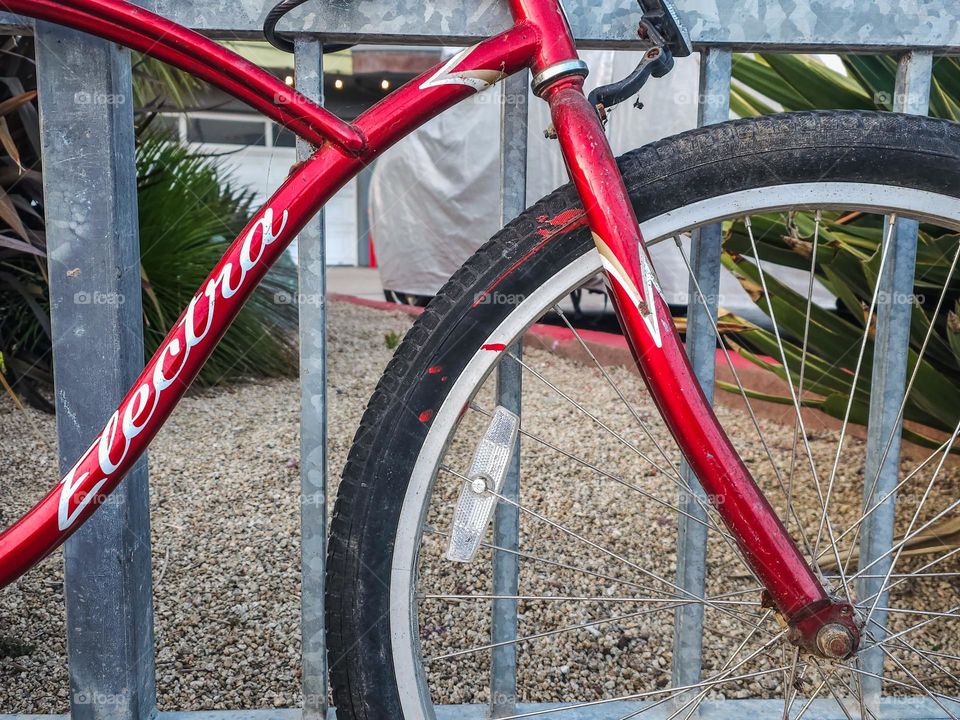  Abstract Vintage red bicycle along a fence