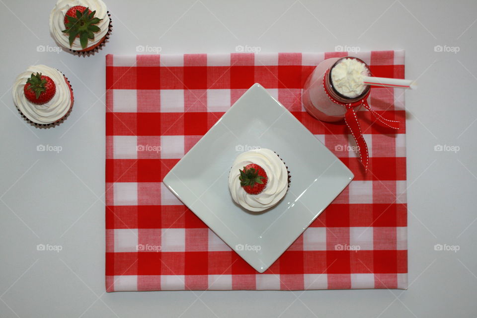 High angle view of cupcakes and smoothie