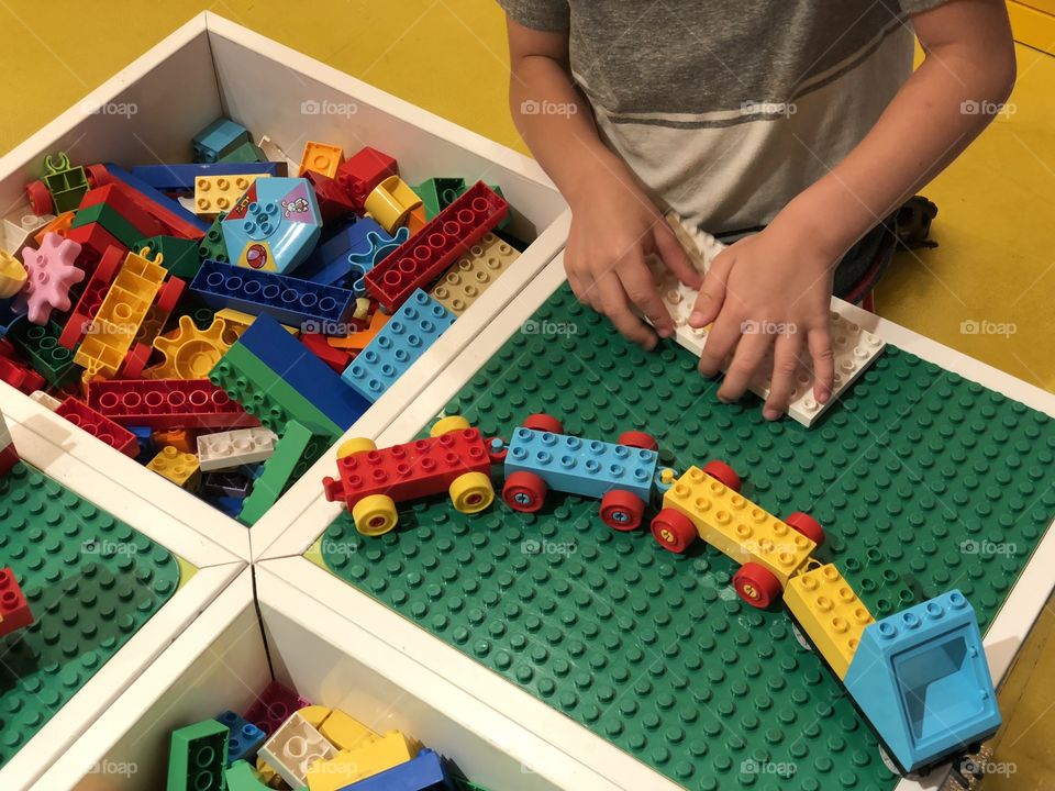 Hands playing with lego blocks 