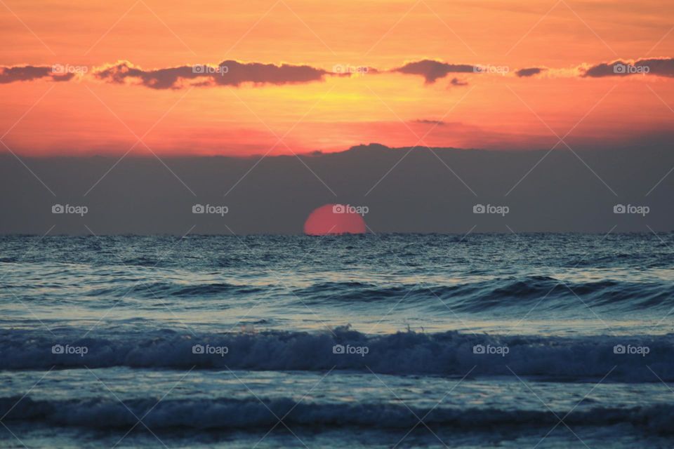 half sunrise sunset on sea