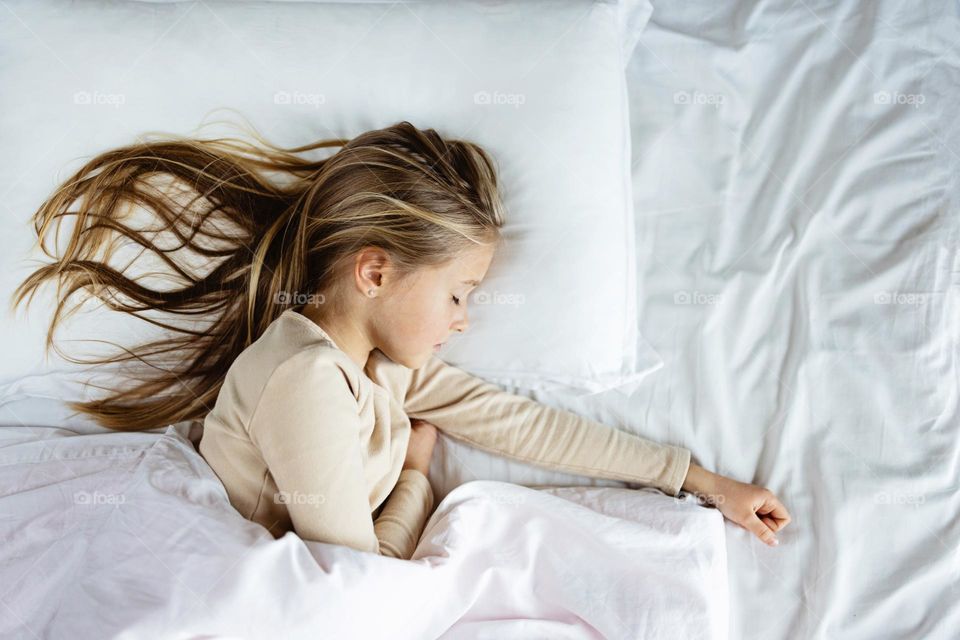 Beautiful blonde hair girl sleeping in bed