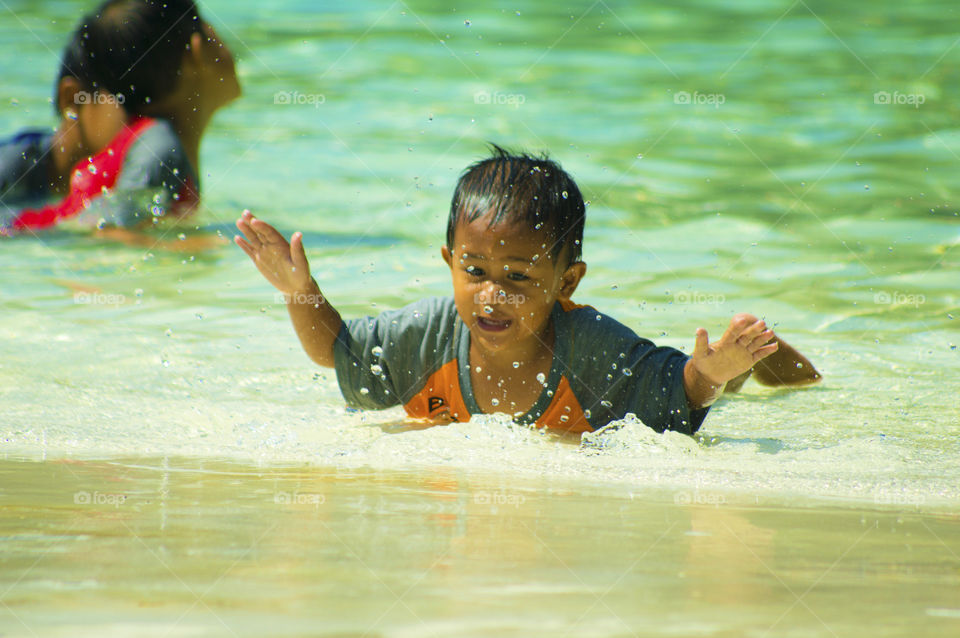 Boy swimming in sea