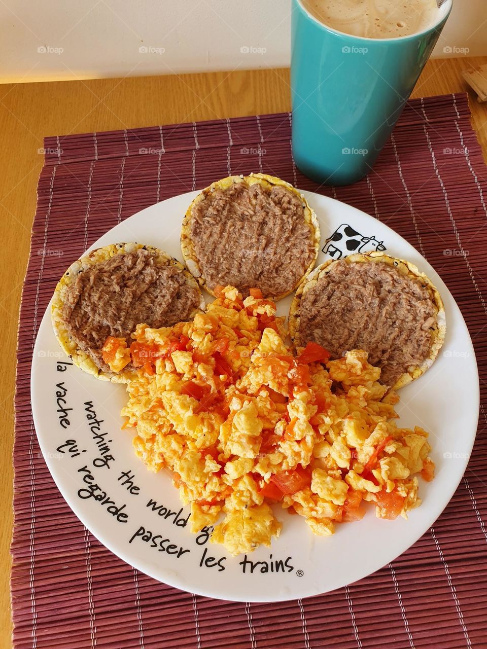 Colorful breakfast with eggs and tuna sandwiches.