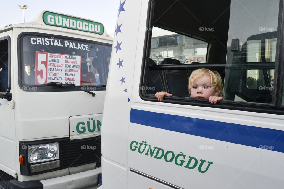 little girl looking curious out of the bus window before the local bus leaves the local bus stop in Alanya in Turkey.

The little Swedish girl is Wilda Hilner 2 years old at the time, in Turkey with her mom and dad (photographer) on vacation.

For further info if needed contact (Photographer, dad) Jens C Hilner +46 762142730 info@photomedia.se