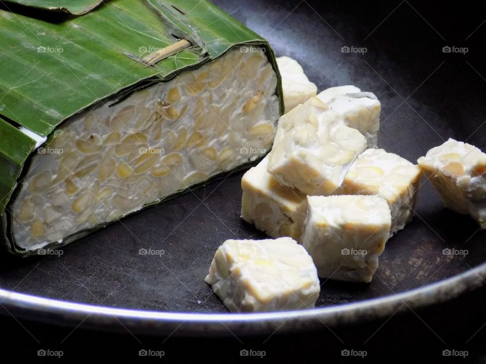 Tempe: processed from soybeans wrapped in banana leaves.
