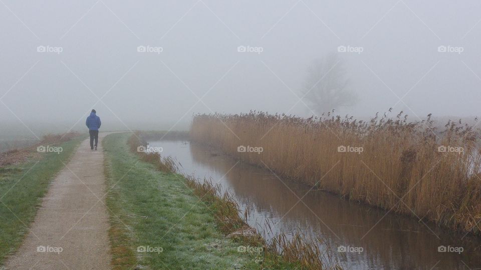 man walking in the mist alone