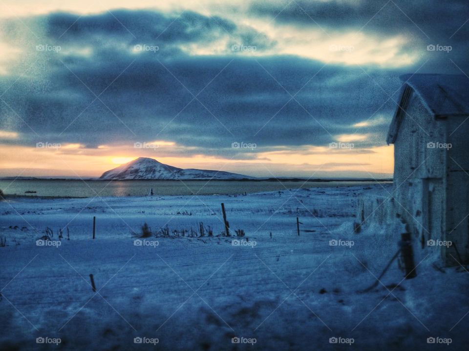Lake cabin in a snow day