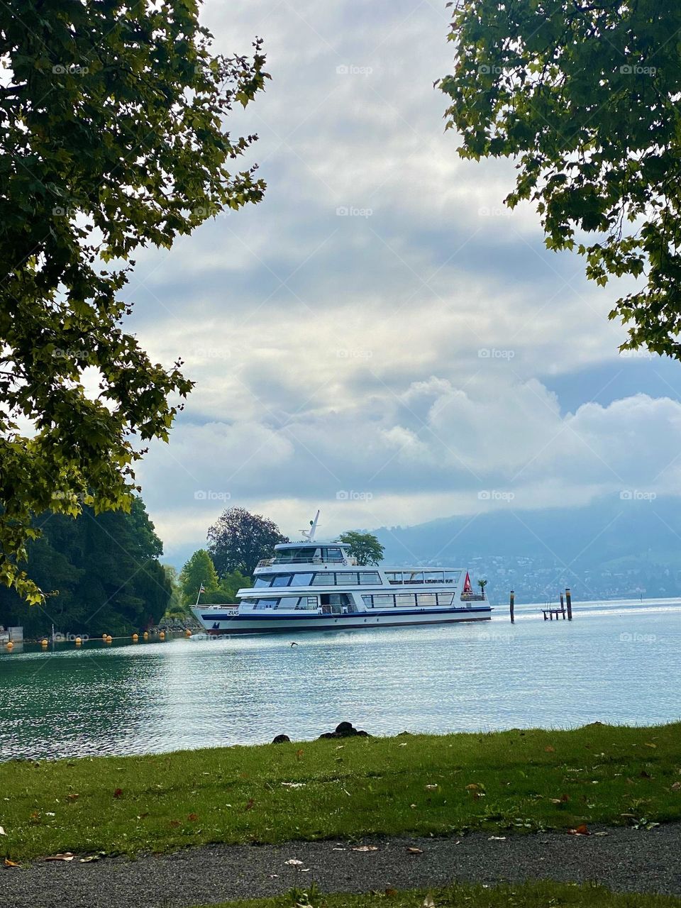 beautiful Swiss landscapes of a Swiss lake with the Alps and a ship on the water.  autumn is coming