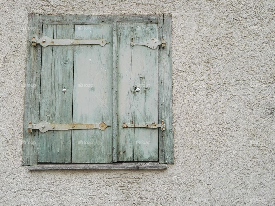 Closed wooden window on wall