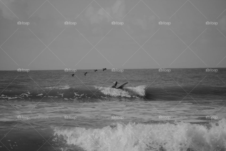 Woman surfing Folly Beach South Carolina