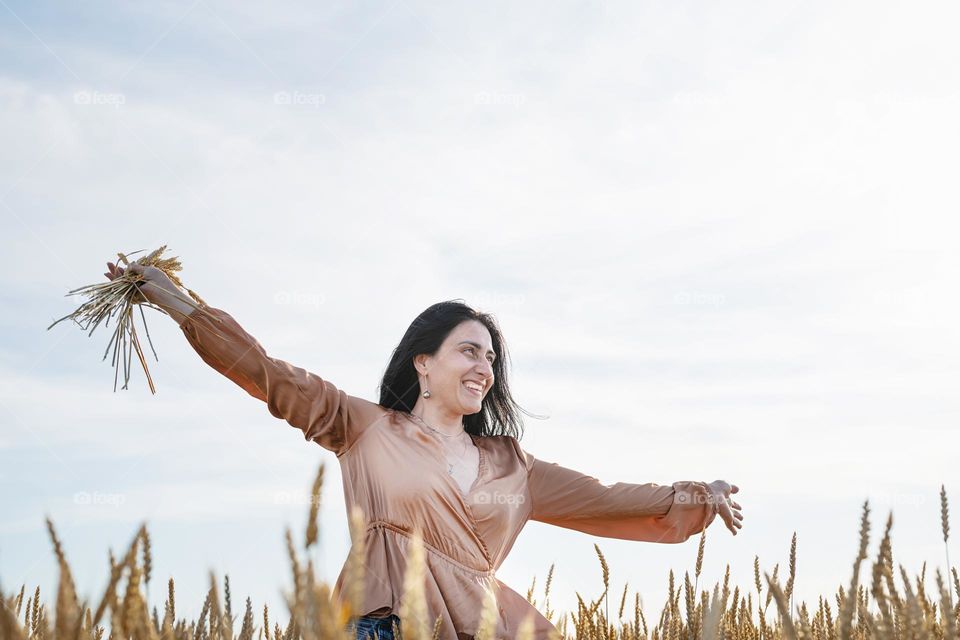 woman dancing in wheat field