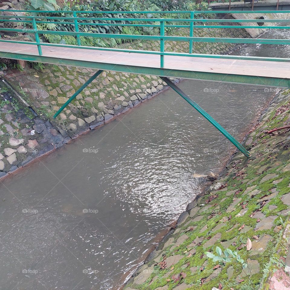 green bridge over the river with clear water