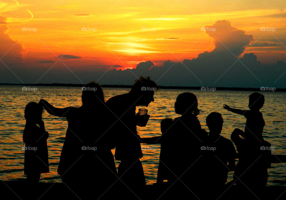 Silhouette of people enjoying at beach