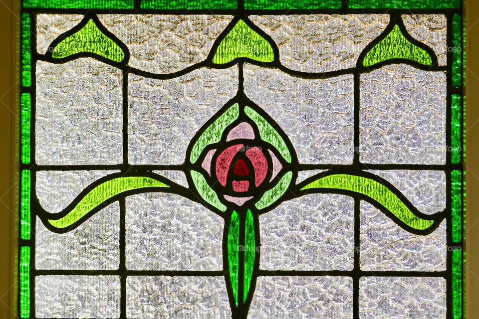 Antique circa 1930s stained glass window pinks and greens background image 