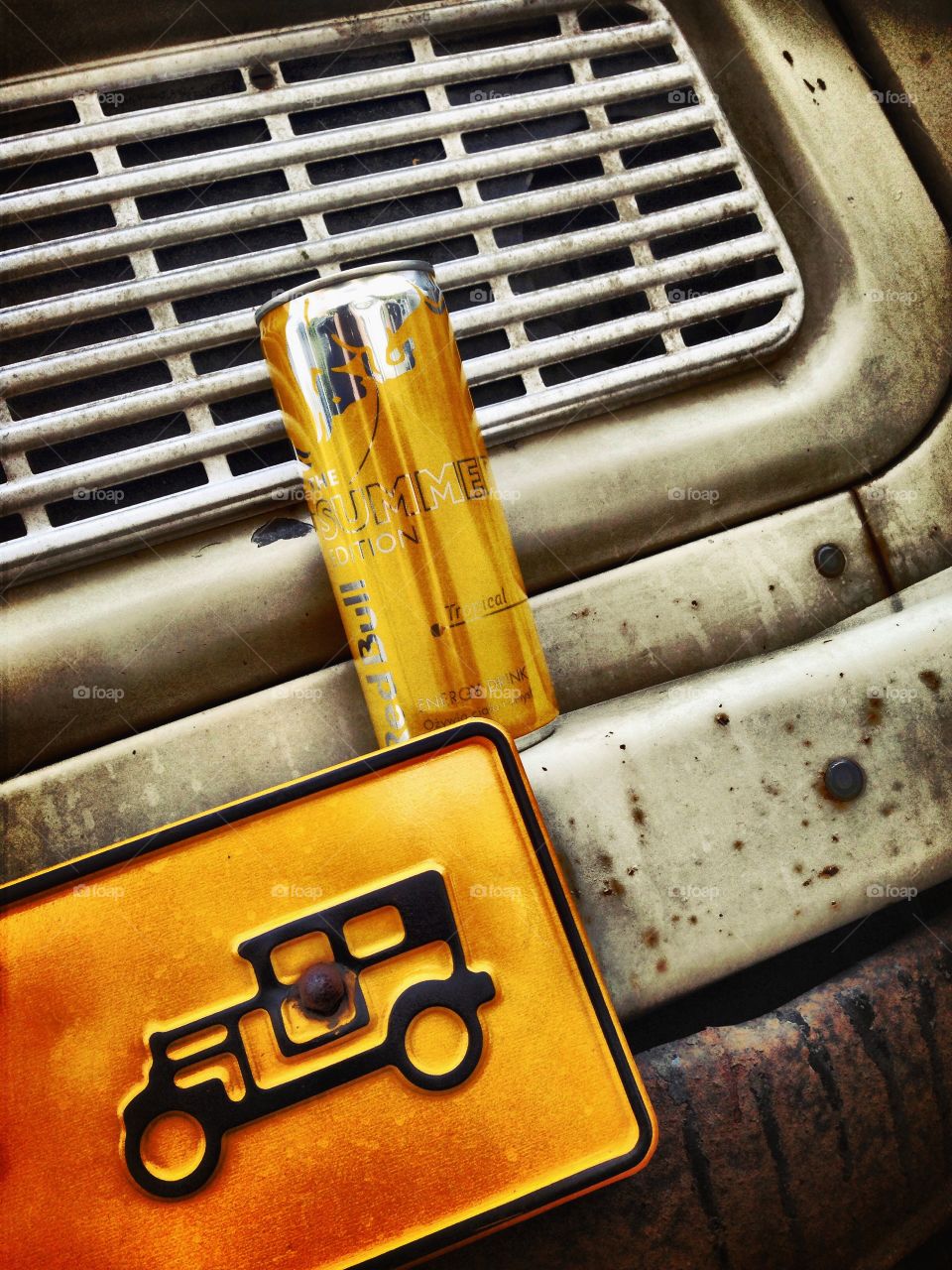 Yellow metal . RedBull and old car 