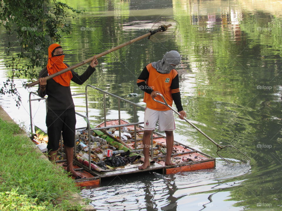 Duo cleaning the canal in Jakarta Indonesia March 2015