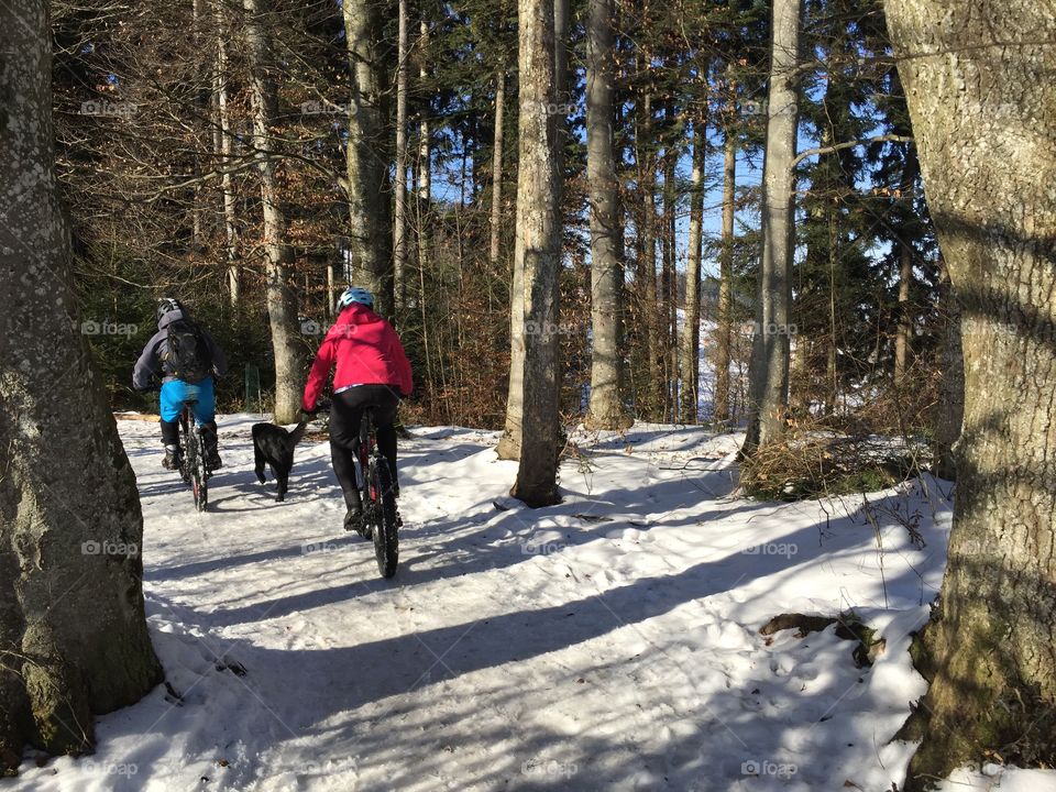 Mountain bikers on their winter trip in the Swiss mountains 