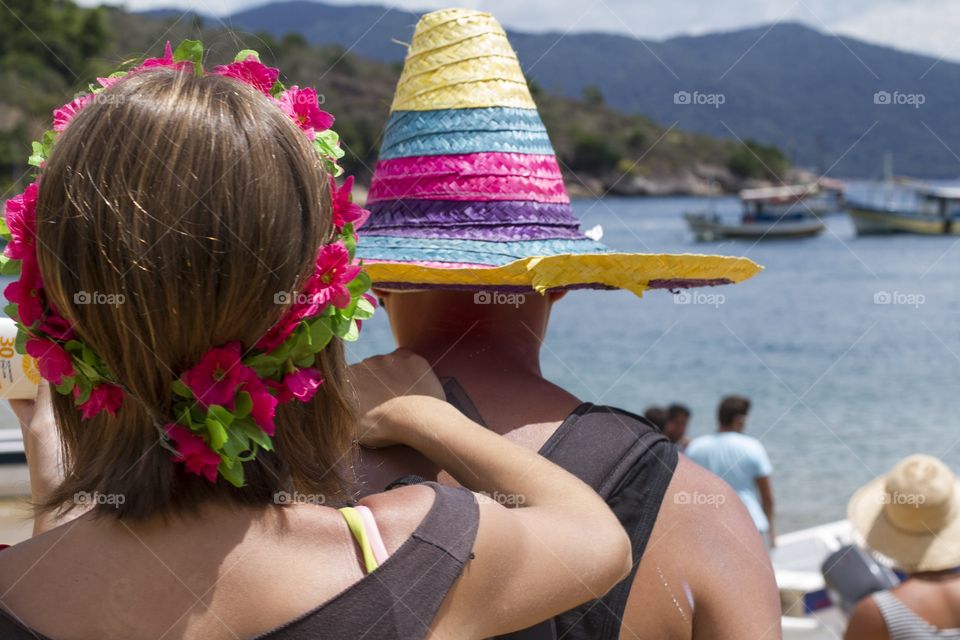 Brazilian carnival . A couple dressed up in carnival costumes at a beach near Paraty, in Rio de Janeiro 