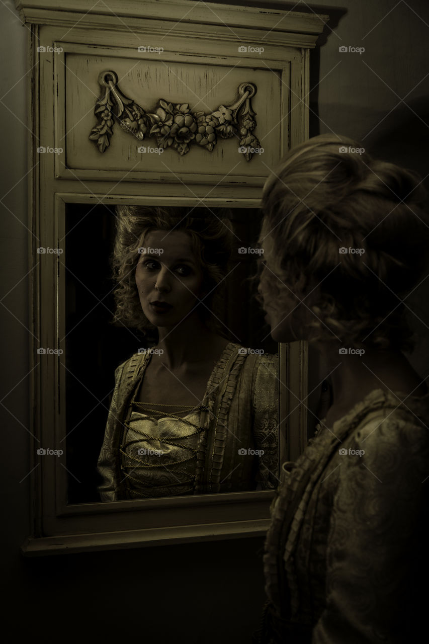 Girl looking in a mirror. Taken during a shoot with a Marie Antoinette theme. 