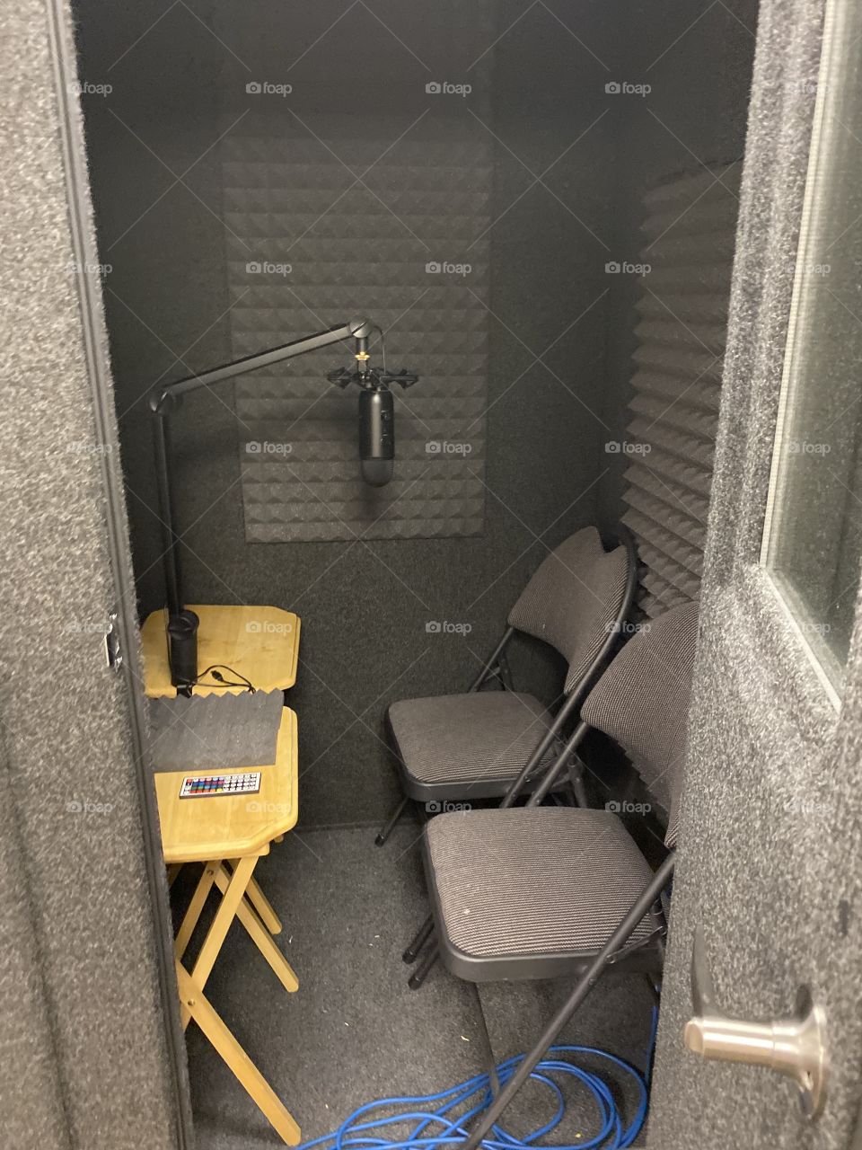 This is my sound studio that I use for voiceover on videos and eLearning. It has sound deadening foam, two seats, lights and a microphone.