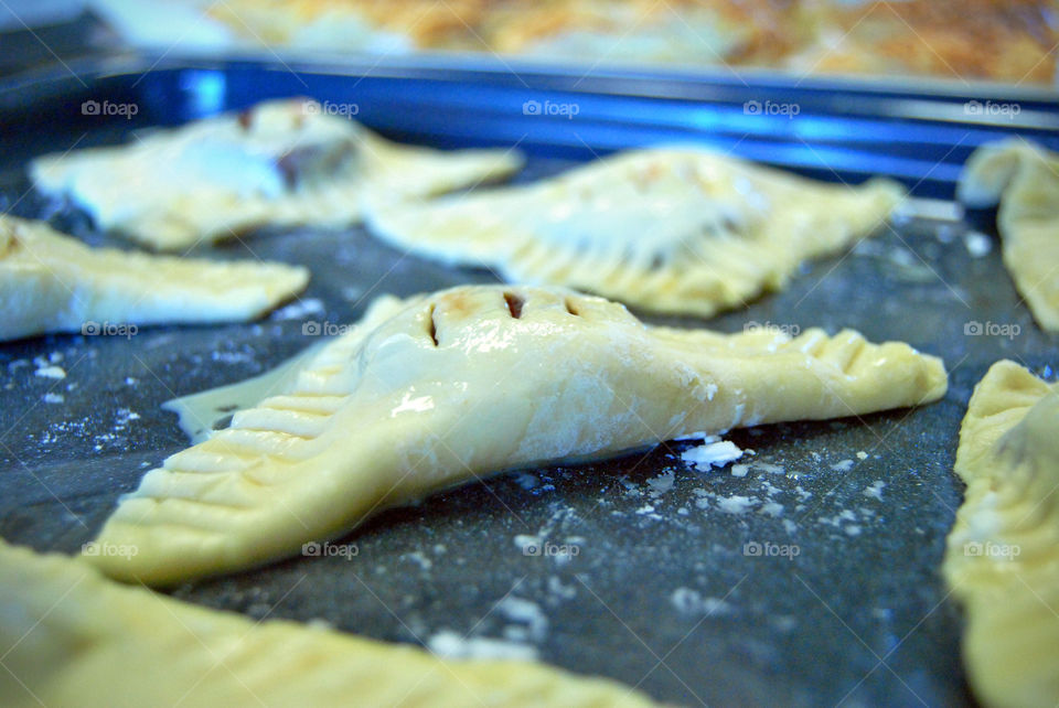 homemade glazed guava cheese strudel before baking, front focus, cooked or finished blurred at background after baking