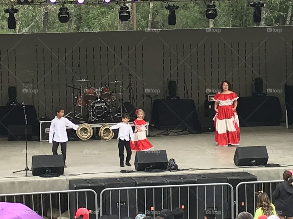 Dancers dressed in red and white perform at Bower Ponds for Canada Day.