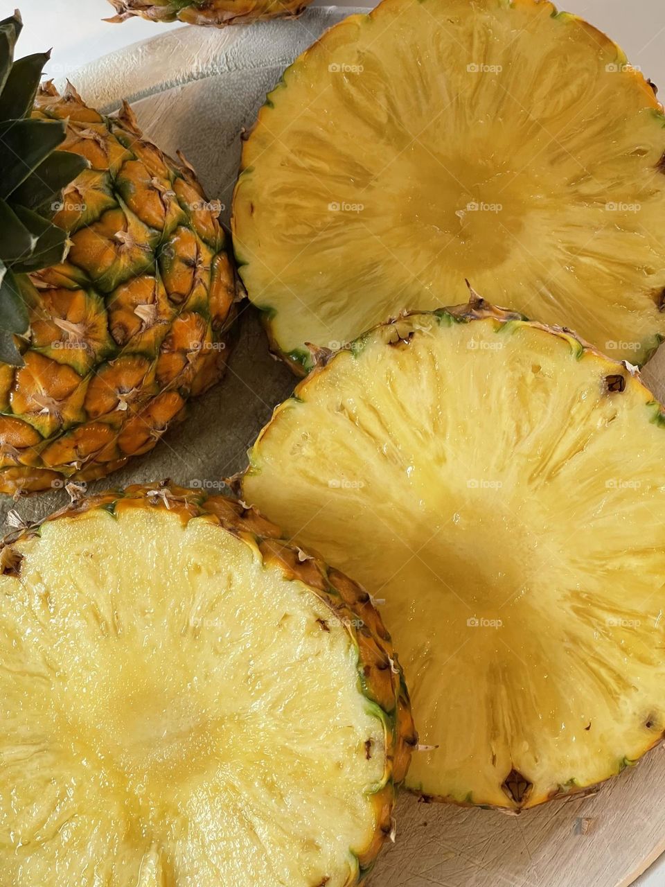 Juicy yellow pineapple slices from above, tropical fruit, Latin American fruit, edible bromeliad 