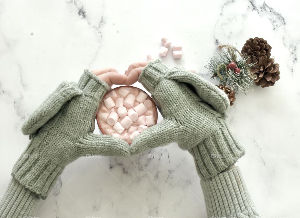 Grey Isotoner gloves holding hot chocolate 