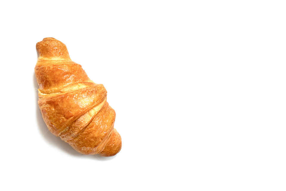 Plain croissant isolated on white, space for text