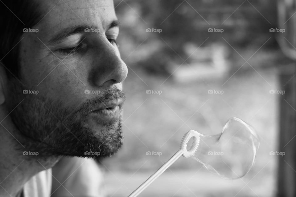 Father blowing soap bubbles 