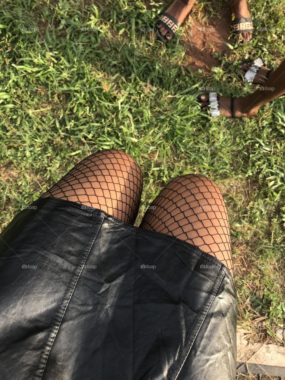 Fishnet socks with black leather skirt
