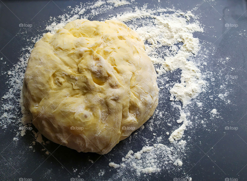 Dough close-up on a dark background.