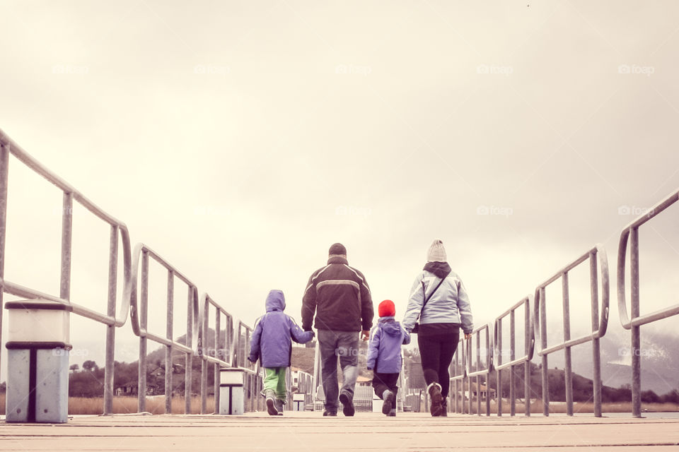 Family walking on bridge