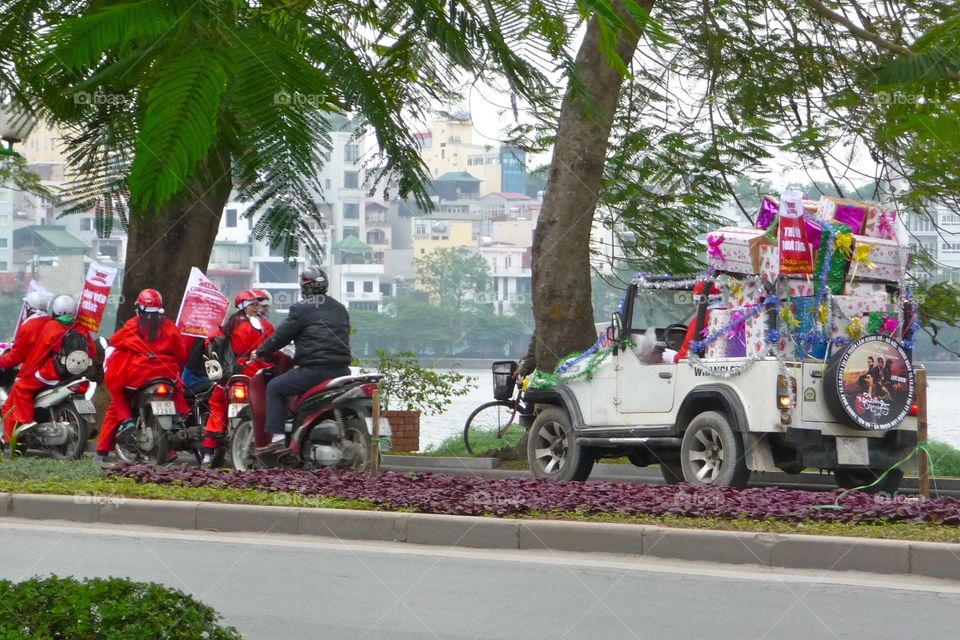 Santa Claus is coming with a bunch of presents - seen in Hanoi during Christmas Time
