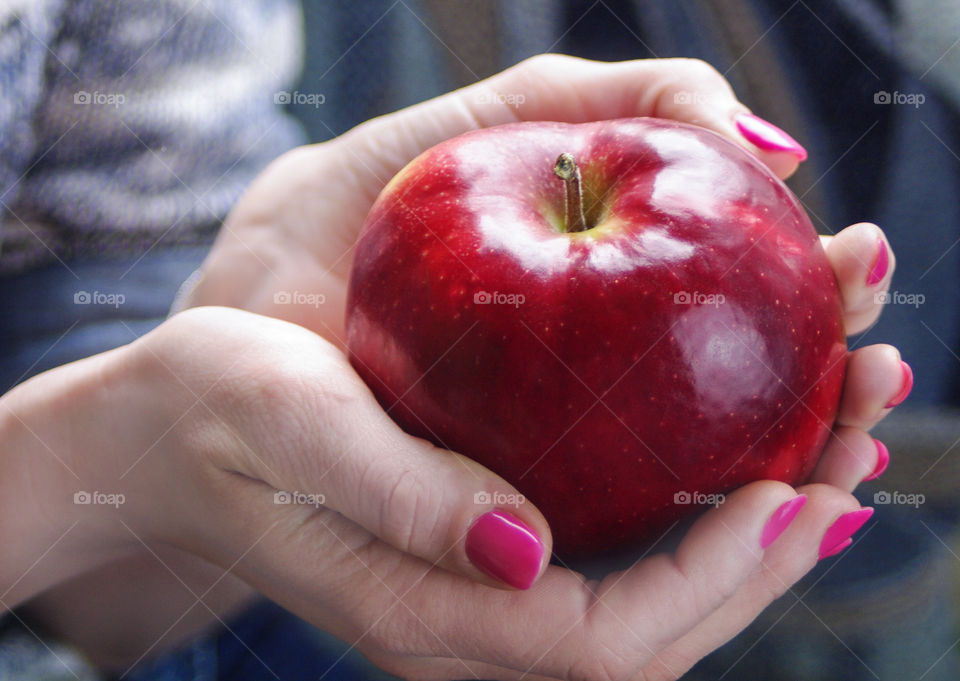 Girl is holding an apple