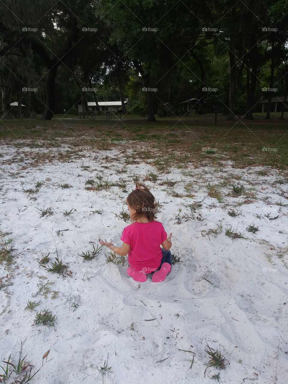 Little girl playing in the sand