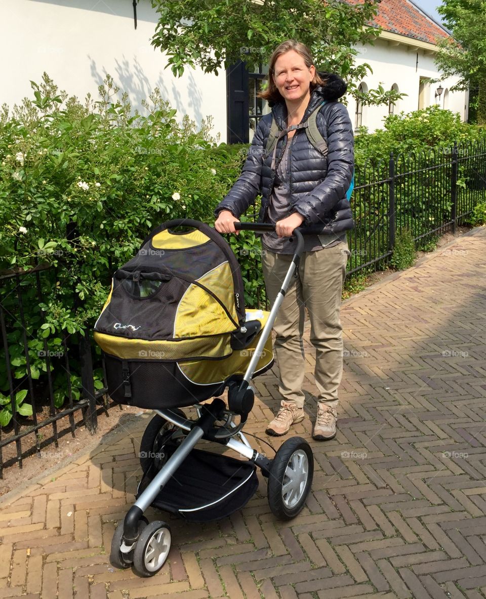 Woman with stroller on the road