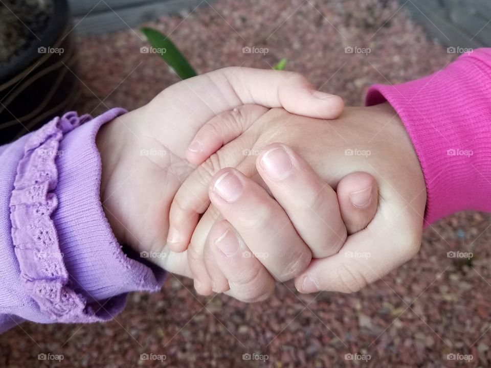 Sisters holding hands