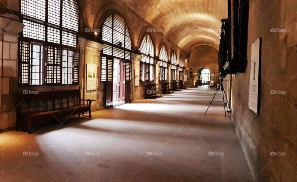 A photo of old hallway with classic style of windows that become more noticeable by daylight.