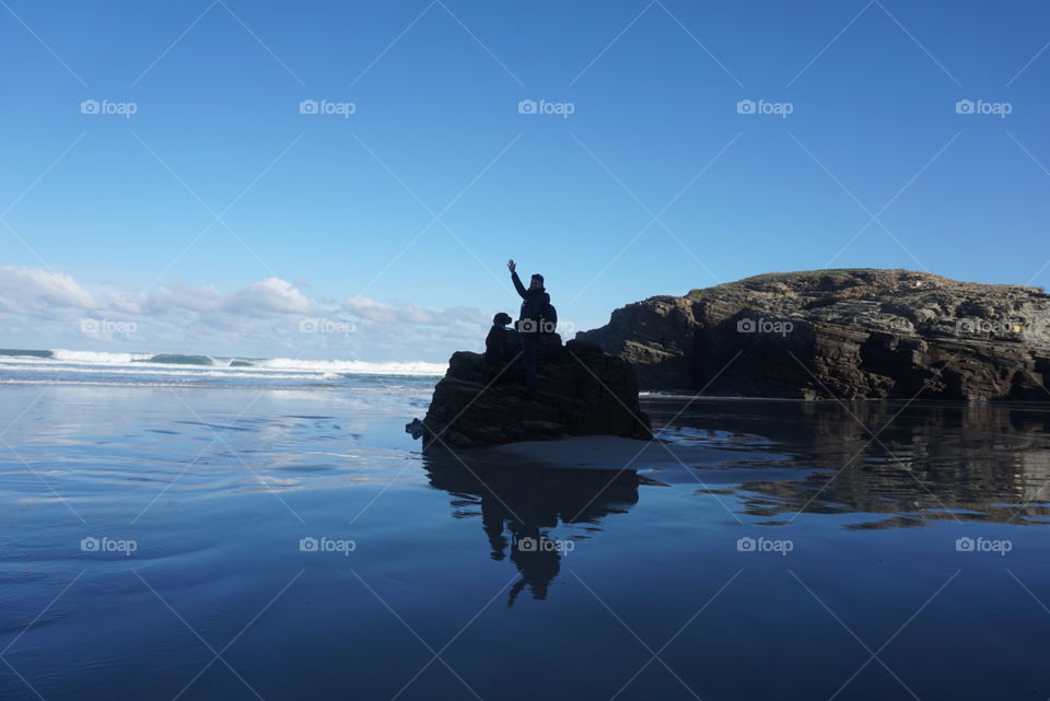 Beach#ocean#sky#rock#human#dog#sand
#reflect