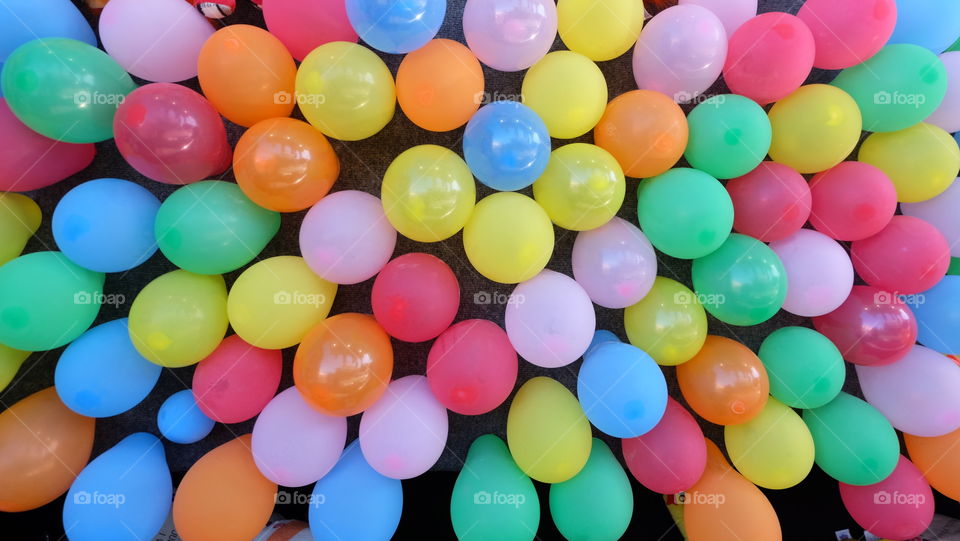 Wall of multicolored balloons in a fair