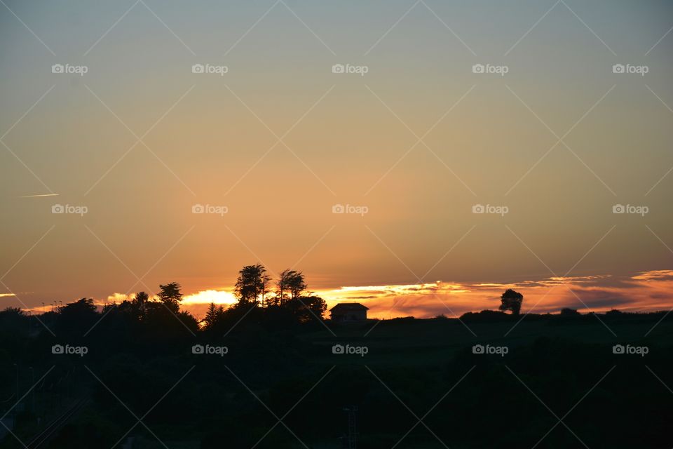 a beautiful sunset with trees