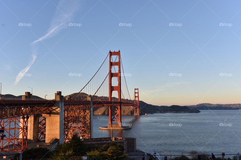 Painted in International Orange, the Golden Gate Bridge welcomes tourists and locals alike, spanning across the strait of San Francisco Bay.