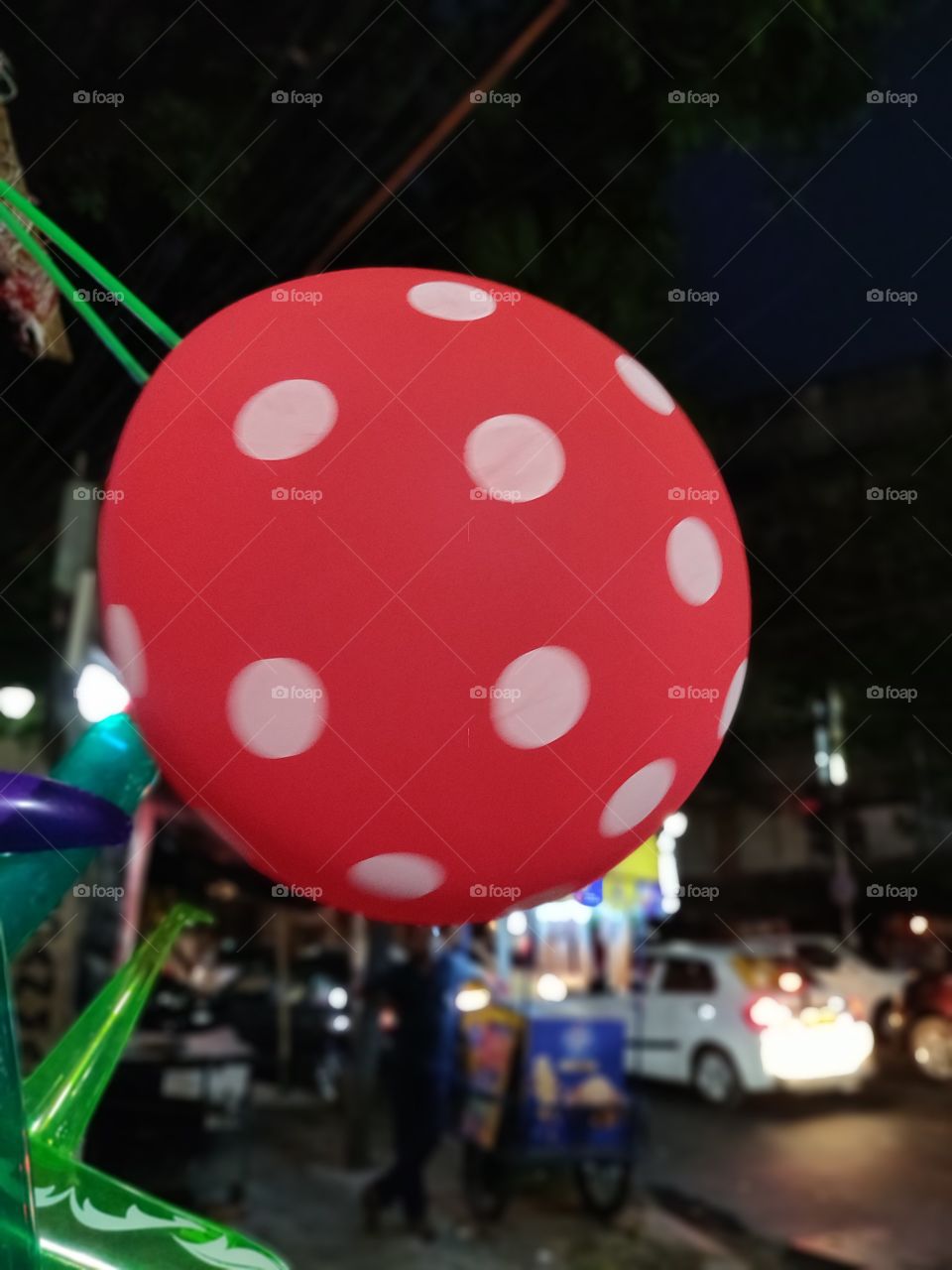 red balloon with white dots on