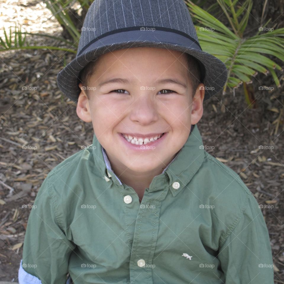 Smiling little boy wearing hat